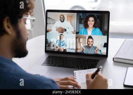 Webcam group conference with coworkers on modern laptop from home office Stock Photo