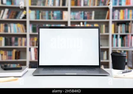 Closeup laptop display computer monitor view over table in university library Stock Photo