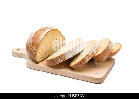 Fresh loaf of bread sliced on wooding cutting board on white background. Stock Photo