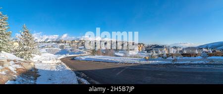 Plowed road in the snow covered residential community of Draper in Utah Stock Photo