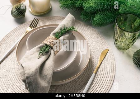Christmas festive table setting with ceramic plate, linen napkin, cutlery Stock Photo