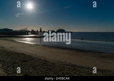 The pier at Clacton on Sea silhouetted by the rising sun. Essex UK. April 2021 Stock Photo
