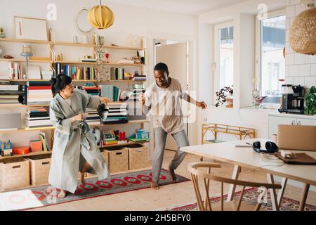 Cheerful couple dancing in living room at home Stock Photo