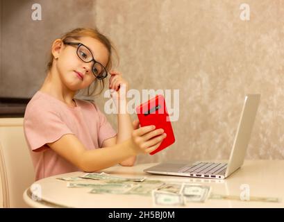 Modern little girl holding a red phone, great design for any purpose. Beautiful female face. Corporate business technologies. training and remote work Stock Photo