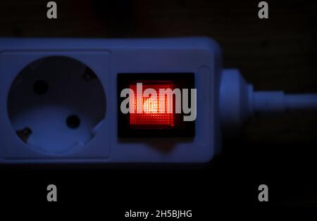 Kaufbeuren, Germany. 08th Nov, 2021. The circuit breaker of a multiple socket is lit up red. Households in Germany continue to pay comparatively much for electricity in a global comparison. Credit: Karl-Josef Hildenbrand/dpa/Alamy Live News Stock Photo