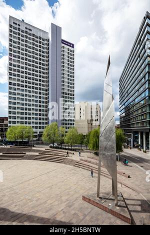 Greengate Square, Manchester, England - April 29 2021: Regenerated urban space in Salford dominated by sculpture and surrounded by hotels and offices Stock Photo