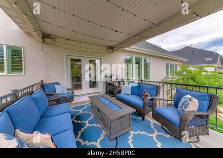 Outdoor patio with blue themed color and string lights hanging on the ceiling Stock Photo