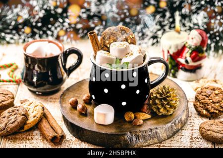 vegan christmas hot chocolate with cinnamon, cream, marshmallow, mint and hazelnut. New year's hot drink. Stock Photo