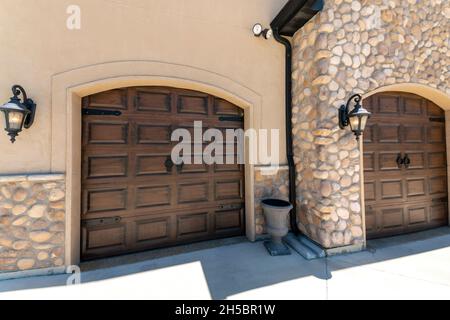 Rustic side hinged garage doors with arched door openings Stock Photo