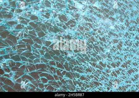 Broken and cracked dirty window glass into thousand of pieces Stock Photo