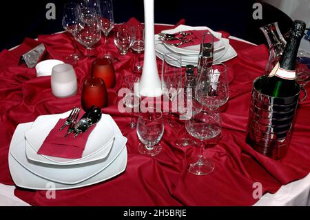 Empty glasses and plates served on the table of a luxury restaurant with champagne Stock Photo