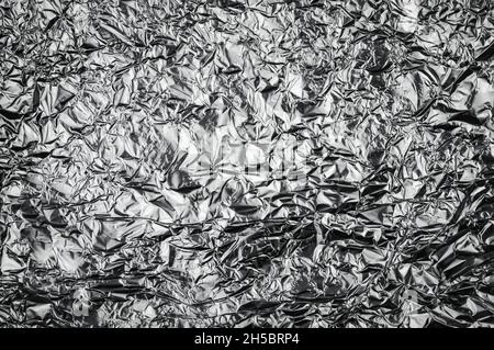 metallic crumpled aluminium foil textured background chrome tinfoil abstract Stock Photo