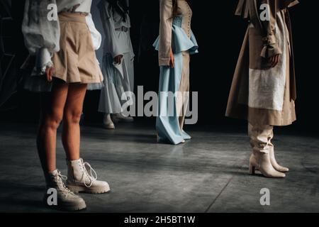 Models in designer stylish outfits on the runway of a fashion show Stock Photo