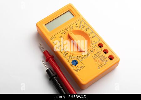 Yellow digital multimeter with probes on white background Stock Photo