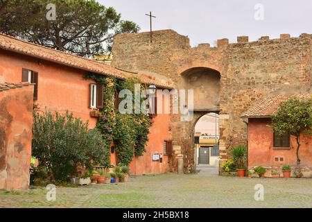 Ostia Antica,Rome,Lazio,Italy-Porta del borgo-Next to the castle of Julius II stands the Renaissance village of Ostia Antica, of medieval origin. Stock Photo