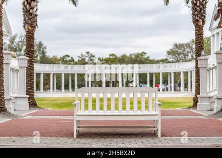 Lyceum lawn green park building in Seaside, Florida winter with white new urbanism architecture, bench and green grass on cloudy day Stock Photo