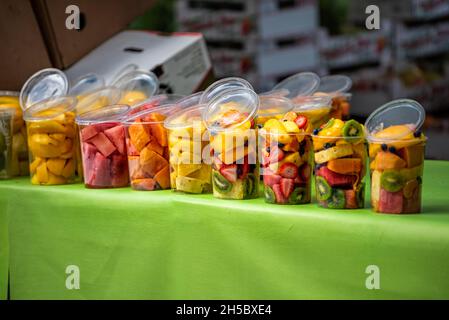 Miami South Beach Lincoln road street produce fruit stand stall at farmers market with cups of fresh sliced cut fruit for healthy breakfast Stock Photo