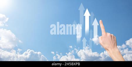 Forex market concept with buisnessman hand carries digital tablet screen and virtual financial chart graphs and arrows.Hand holding a rising arrow, re Stock Photo