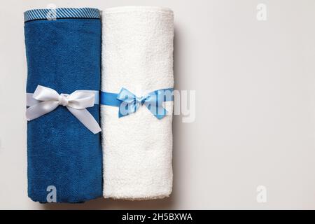 New white and blue terry towels on a light gray background. Top view flat lay copy space Stock Photo