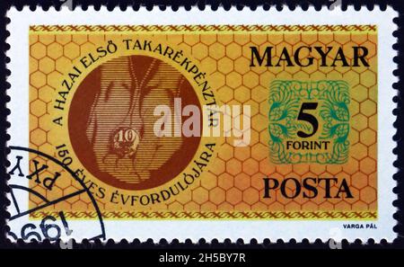 HUNGARY - CIRCA 1990: a stamp printed in Hungary dedicated to Hungarian savings bank, 150th anniversary, circa 1990 Stock Photo