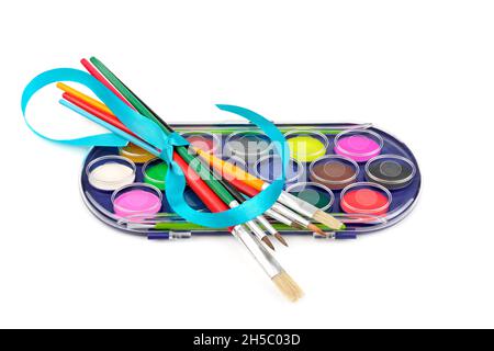 Watercolor paints and brushes isolated on white background. Top view. Stock Photo