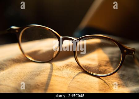 Eyeglasses with dusty lens in warm sunlight Stock Photo