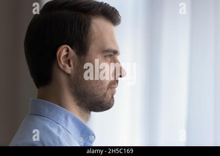 Dreamy confident young man looking in distance. Stock Photo