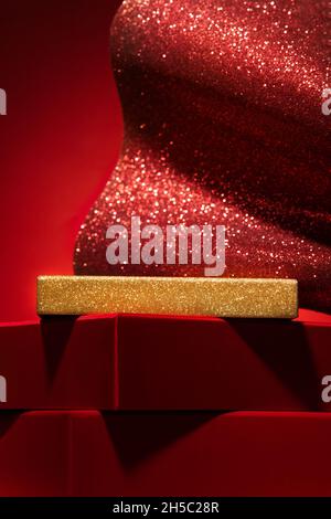 Majestic empty red podium made of gift boxes and shiny decor. Red background .. Pedestal, showcase for products and cosmetics. Chinese New Year concep Stock Photo