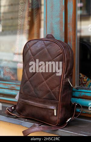 Brown leather backpack on the windowsill Stock Photo