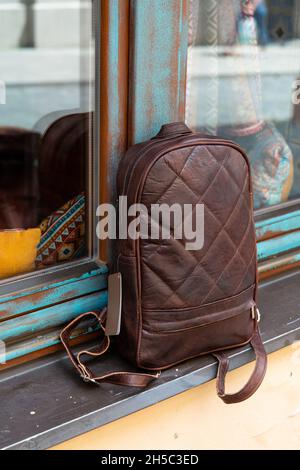 Brown leather backpack on the windowsill Stock Photo