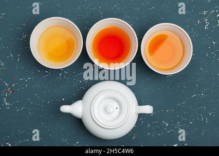 Collection of different teas in cups with tea leaves Stock Photo