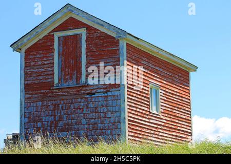 An old red barn on a grassy hill Stock Photo