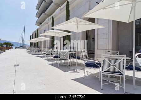 Street cafe without people with empty tables in the European city. Stock Photo