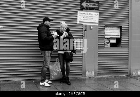 Bury, Lancashire, Britain, Uk couple eating food in town centre Stock Photo