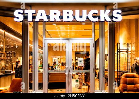 Miami Beach, USA - January 20, 2021: Famous Lincoln road shopping street with sign entrance exterior for Starbucks coffee cafe restaurant store in Flo Stock Photo