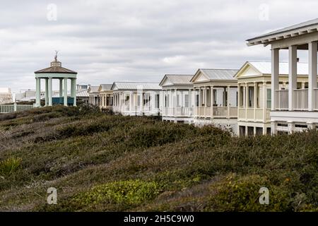 Seaside, USA - January 9, 2021: Cityscape coastline of town with gazebo pavilion in new urbanism architecture on beach ocean in Florida panhandle Stock Photo