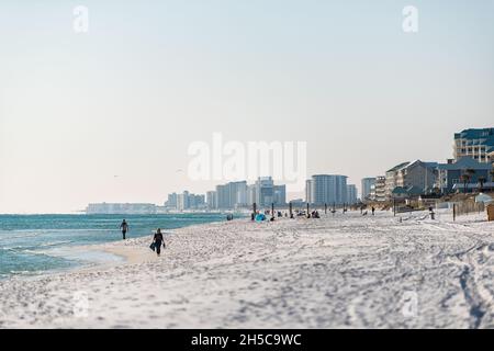 Miramar Beach, USA - January 13, 2021: Beach town near Destin, Florida panhandle gulf of mexico with shore water and people walking buildings in dista Stock Photo