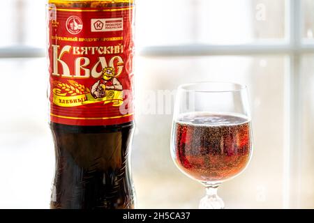 Herndon, USA - December 17, 2020: Plastic bottle of storebought traditional Russian Kvass fermented bread drink with glass illustrative editorial on h Stock Photo