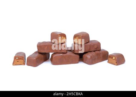 Chocolate bar (with hazelnut, pistachio and caramel filling) on ​​an isolated white background Stock Photo