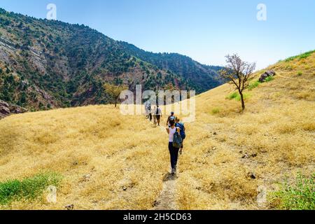 August 25, 2016, Shirkent, Tajikistan: A group of tourists on a trail in Hissar Valley in Tajikistan Stock Photo