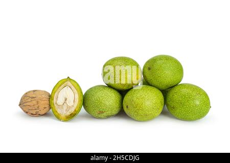 Fresh green walnuts on isolated white background Stock Photo