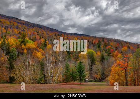 Hunter Mountain Catskill NY - Colorful fall foliage covers Hunter Mountain in the Catskill region of the Hudson Valley in New York. A small shed can b Stock Photo