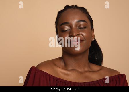 Closeup portrait of delighted black woman, copy space Stock Photo