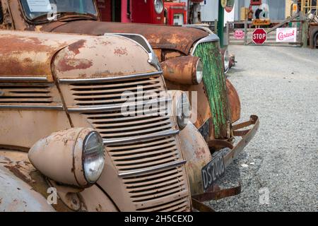Vintage pick-up trucks at Three Creeks service station, Burkes Pass, MacKenzie Country, Canterbury, South Island, New Zealand Stock Photo