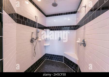 Bathroom interior with black and white tile flooring and walls Stock Photo