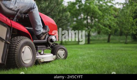 Close-up of an equestrian landscape architect on a lawn mower. Copy -space. Stock Photo
