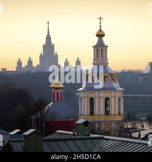 Orthodox church with the Lomonosov Moscow State University building on the background Stock Photo