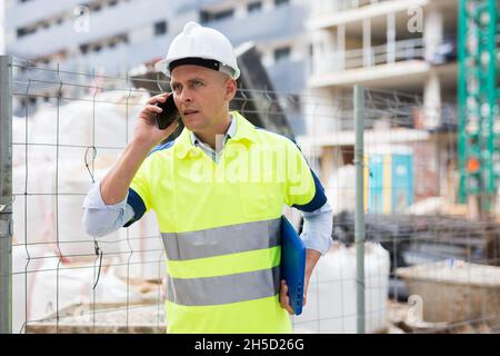 Young engineer is talking on a mobile phone Stock Photo