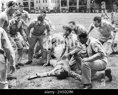 Burt Lancaster (center kneeling), on-set of the Film, 'From Here to Eternity', Columbia Pictures, 1953 Stock Photo