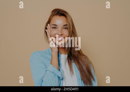 Close up portrait of positive happy woman in white tshirt and blue shirt Stock Photo